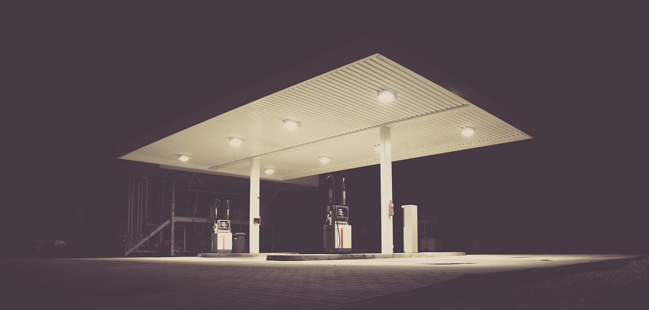 Empty petrol station at night with dramatic lighting, representing rising fuel and business costs in Australia
